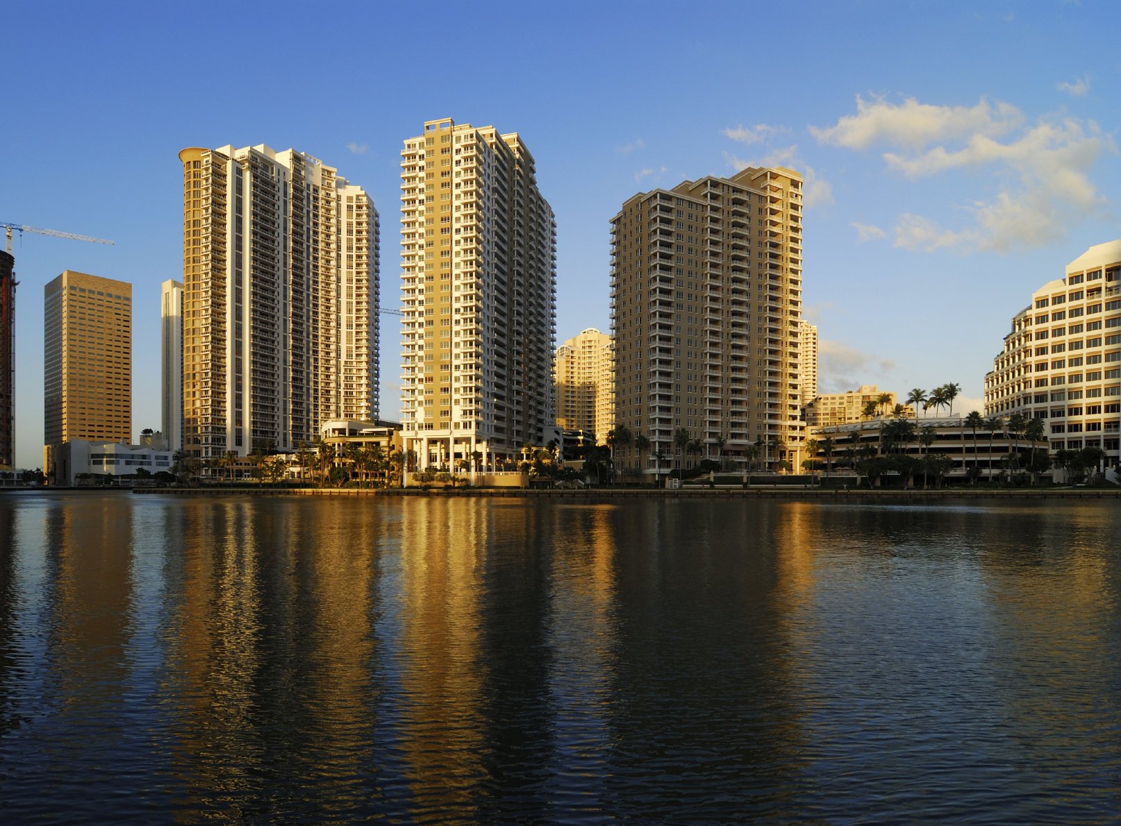 the brickell key buildings reflecting in the bay, behind; miami's dowtown